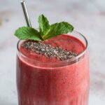 Strawberry smoothie recipe with mint and chia seed garnish
