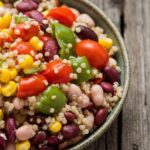 Vibrant dense bean salad recipe with mixed vegetables and herbs
