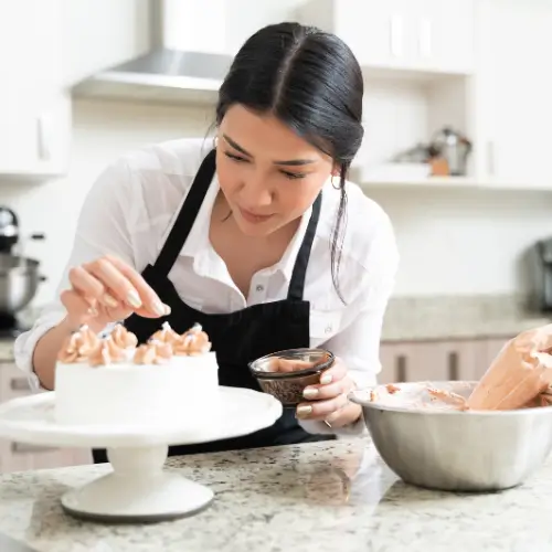 Young chef in a kitchen carefully decorating a cake about passion, creativity, and recipes